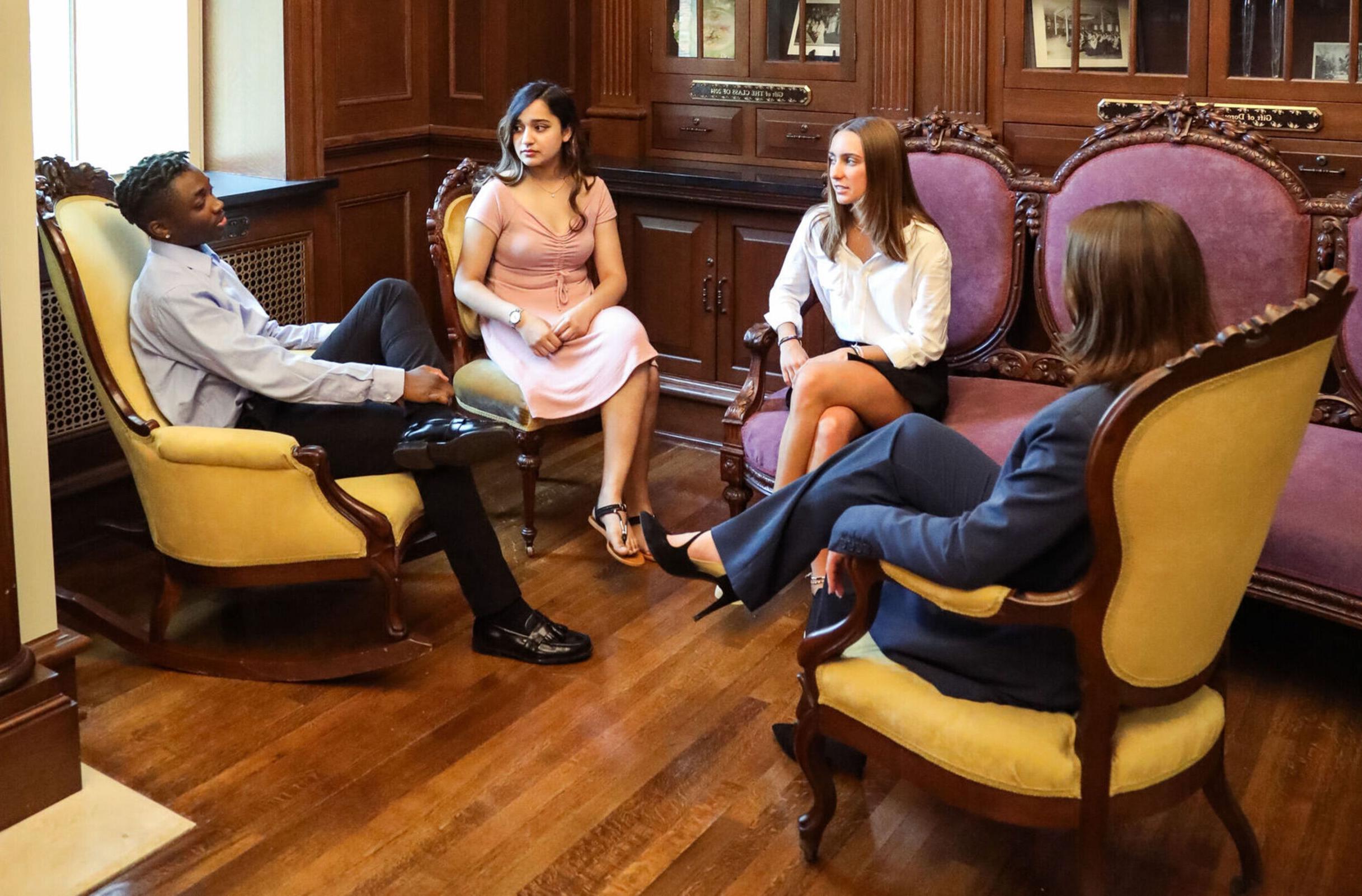 Four business students meet in a comfortable lounge area